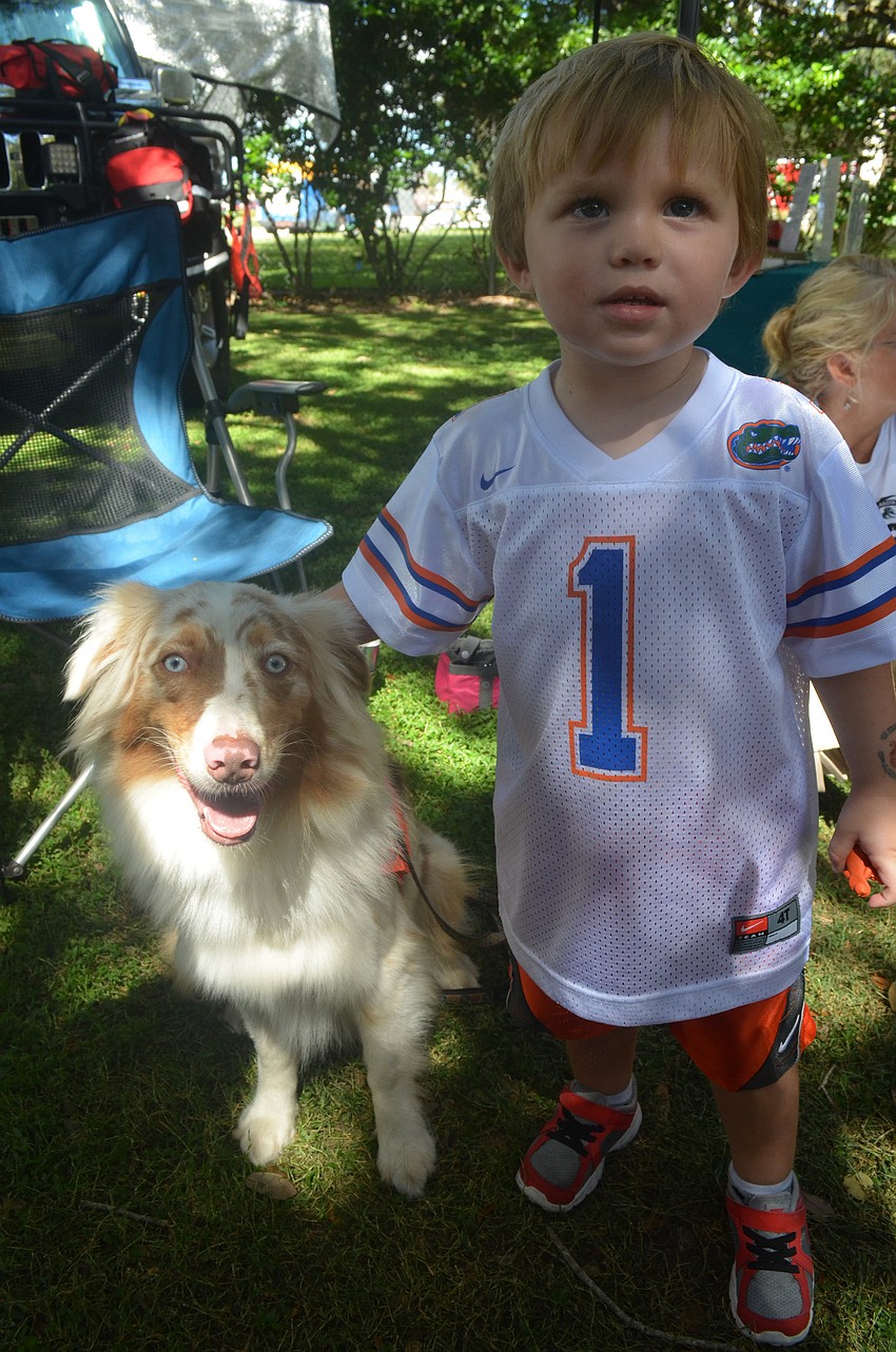 Moe Mooney, 2, meets Piper the Australian shepherd search and rescue dog.