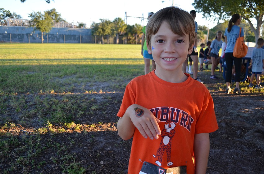 Alex Bates shows off the Halloween tattoo he got in the Kids Fun Zone.