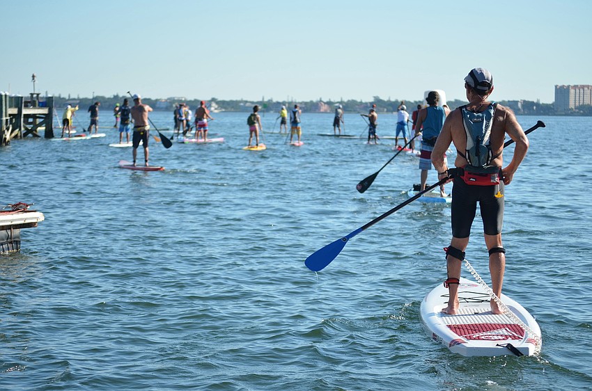 Racers begin to paddle out to the start line.