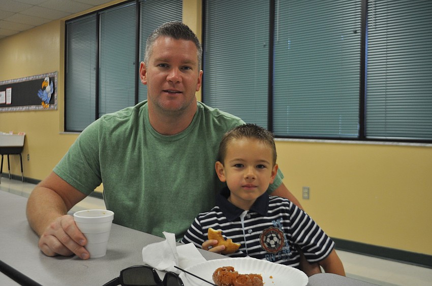 Josh and first grader Tristan Miiller have breakfast together