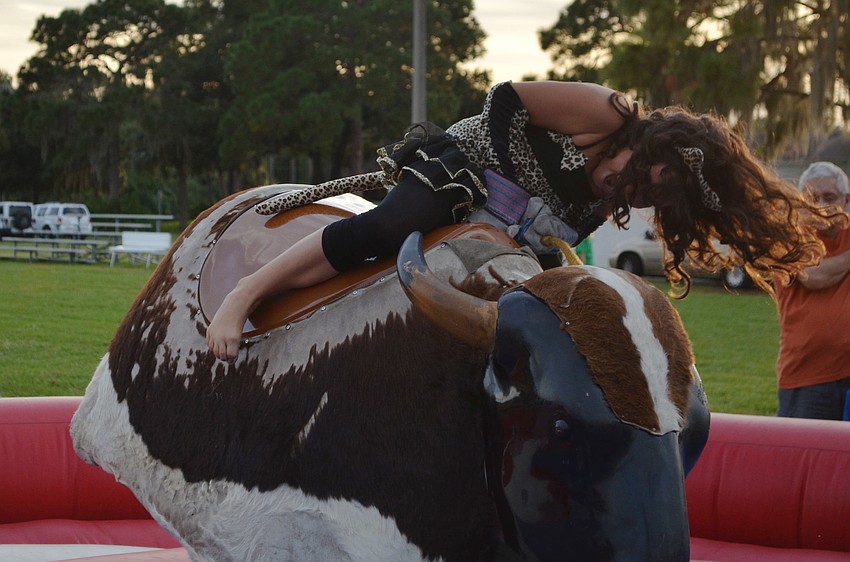 Linda Whitaker rides the mechanical bull.