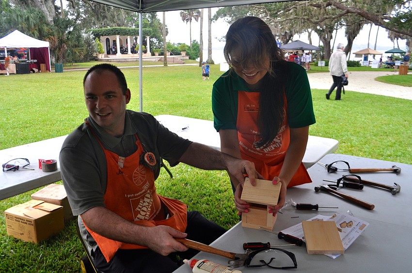 James Sylvester and Diana Segura, of Home Depot, craft wood items.