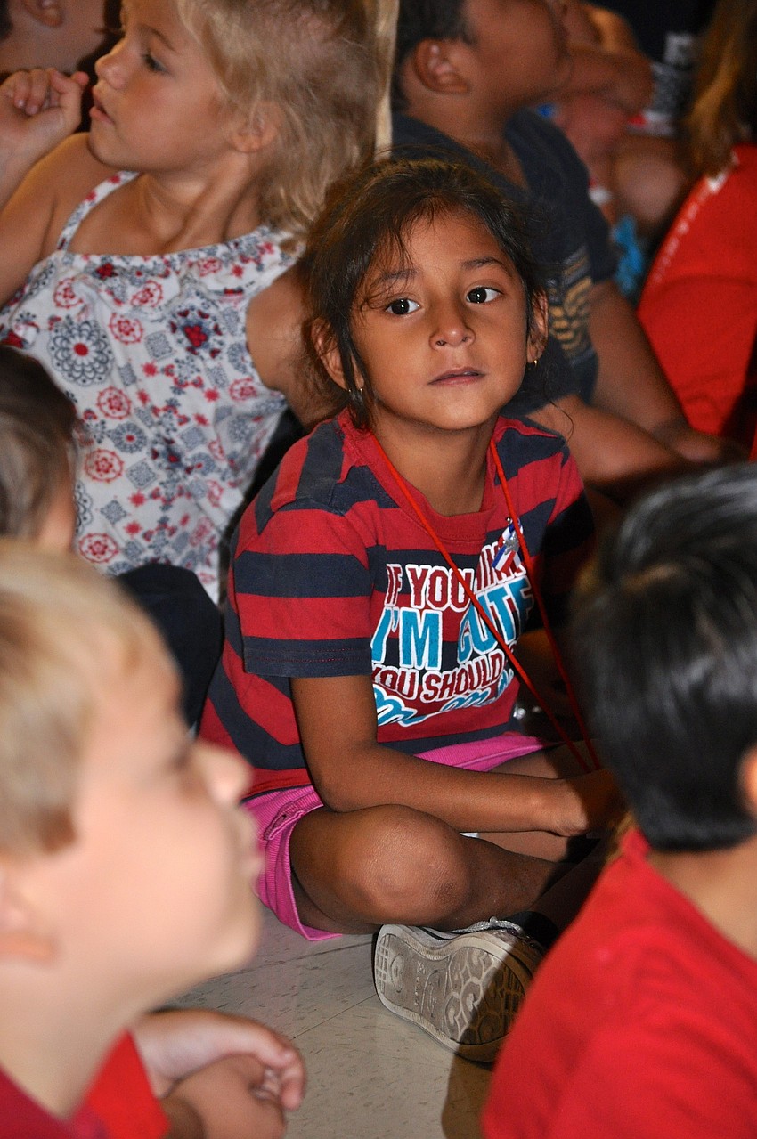 Evera Padilla, 5, listens to patriotic presentations.