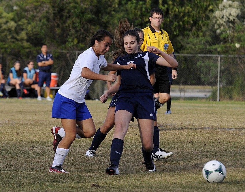 Sarasota Military Academyâ€™s Mia Venafro fights off an Out-of-Door Academy defender during the first half.