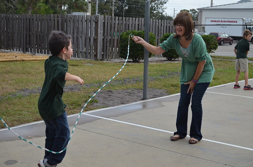 Lisa Edwing helps a first grader jump rope