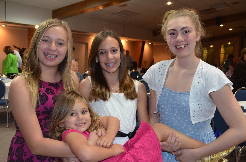 Jolie Mallistz, holds up little sister Dani with Ava Vandroff, and Chelsea Volosin.