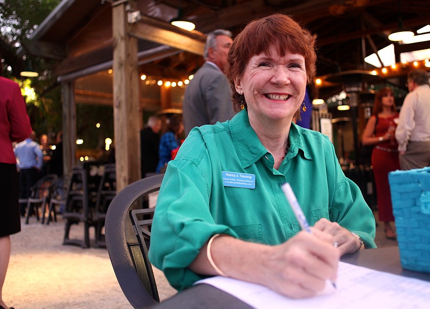 Nancy Taussing, Barefoot Weddings, helped with the sign-in sheet and raffle.
