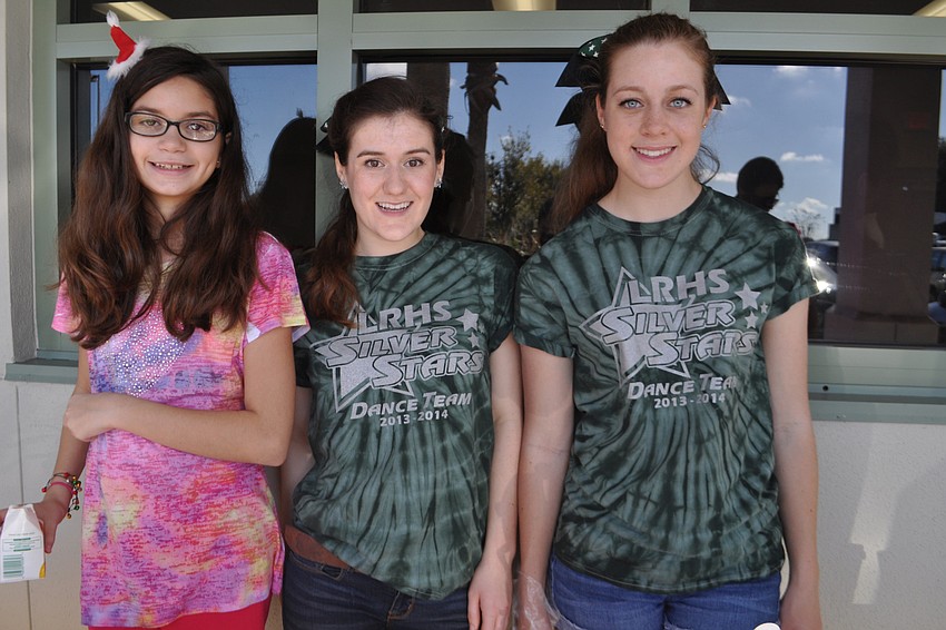 Angelina Ortiz, Michelle Jackson and Veronica Reid serve food attendees.
