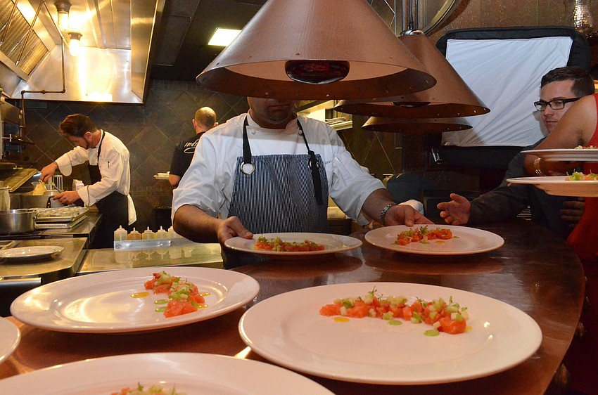 The plates are ready and the first course, Mt. Cook Alpine Salmon Ceviche, by Chef Anthony Lamas is served to the guests.