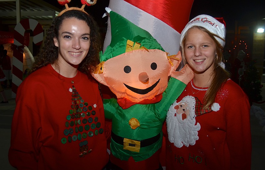 Seventeen-year-olds Regan Cruz and Caroline Imiolek sport red Christmas sweatshirts.