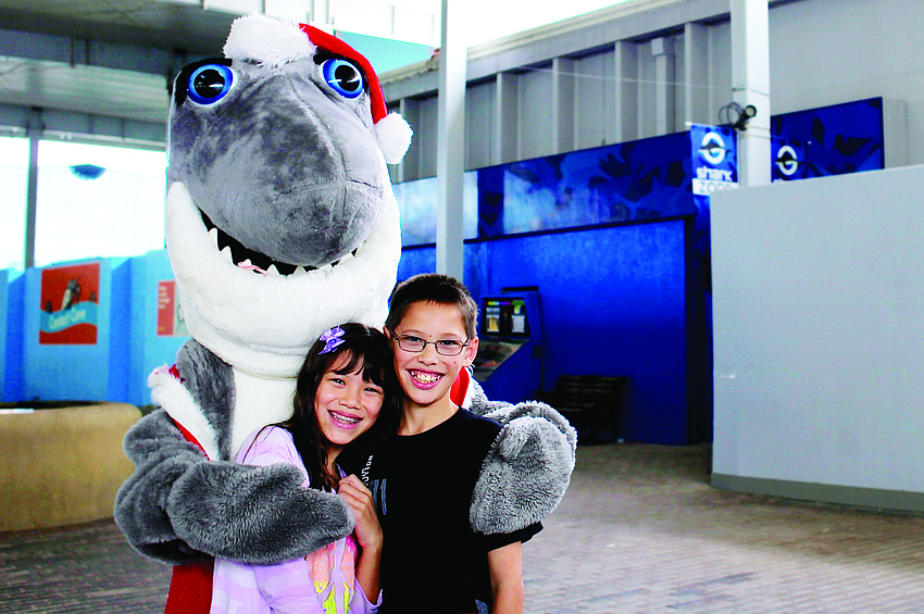 Julia and Brandon Yu pose with Mote Marine Laboratory & Aquarium mascot Gilly the Shark, dressed as Santa Jaws, Nov. 30.