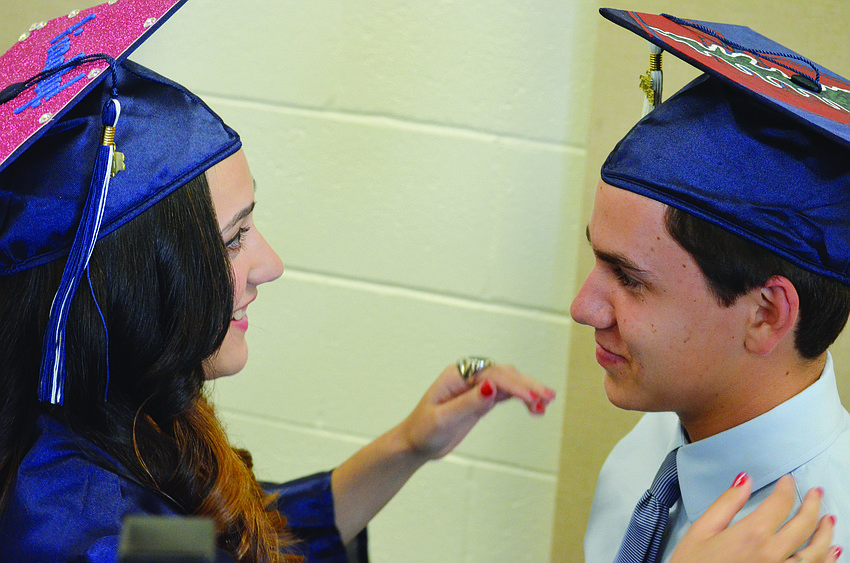Gabriella Alvarez adjusts valedictorian Kevin Moody's cap during The Out-of-Door Academy's commencement ceremonies June 1.