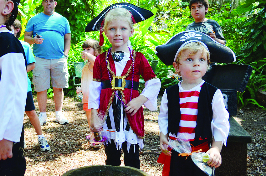 Makayla Digou and Brady Colcu dig for treasure Sept. 14, during International Talk Like a Pirate Day at the Sarasota Childrenâ€™s Garden.