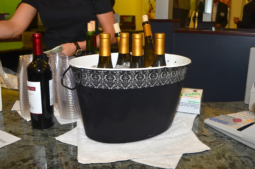 Social attendees enjoy cold beverages at the credit union's kiosk-turned-bar area.