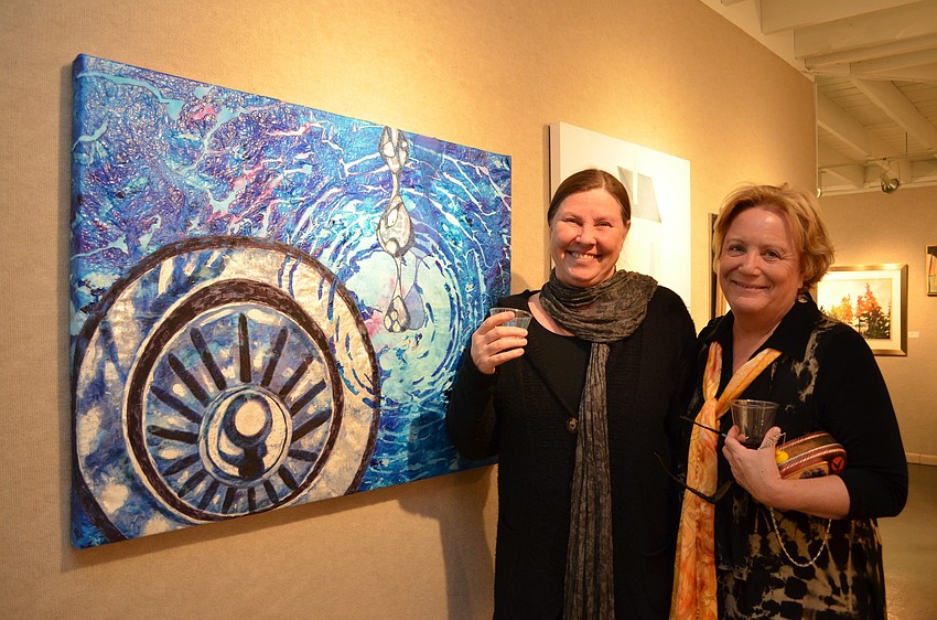 Carolyn Devick and Patricia Turner in front of Turnerâ€™s piece â€œDrippinâ€™ on Down the Drainâ€