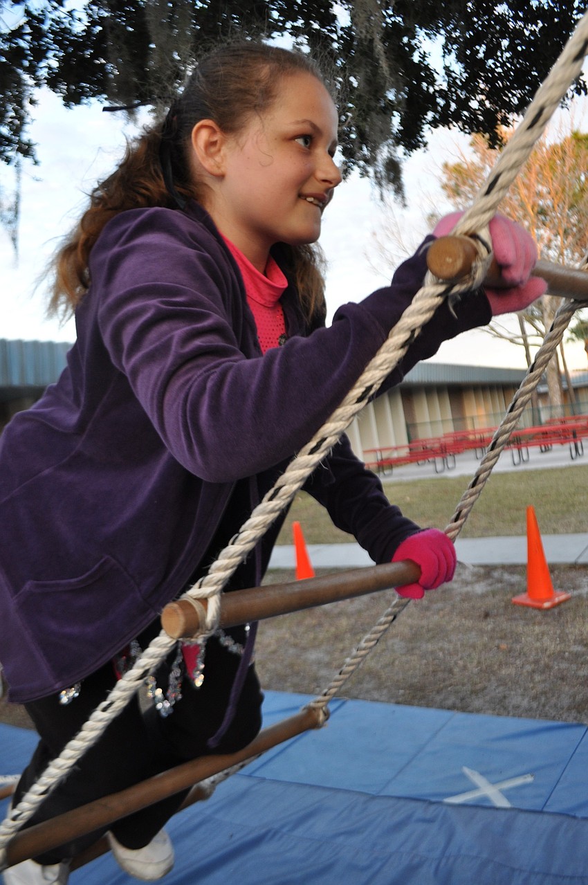 Jayda Espada, 9, makes the rope ladder challenge look easy.