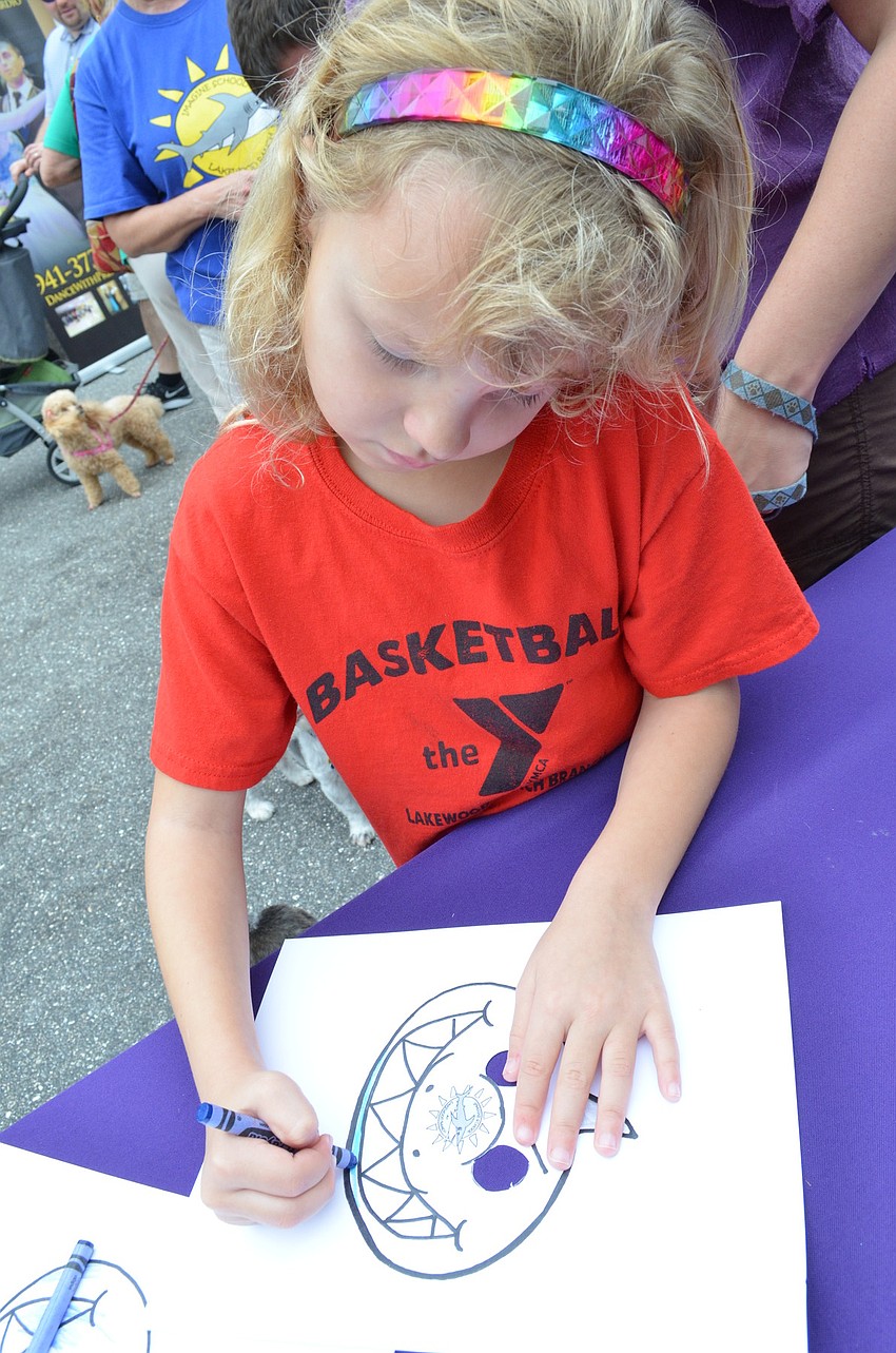 Natalie Magrin colors at the Imagine School booth
