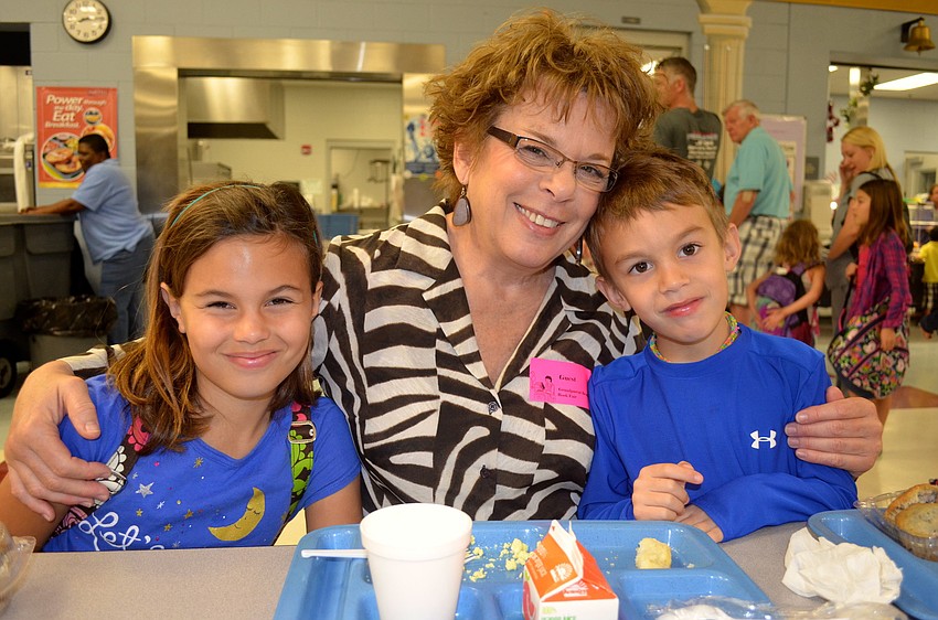 Carlie Baughman, 10, sits with her 