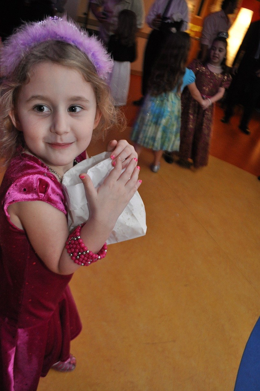Tara Moran, 5, protects her bag of popcorn, while on the dance floor.