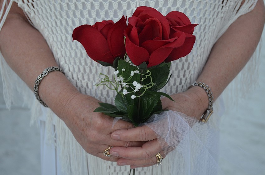 Couples brought their own bouquets and were given roses.