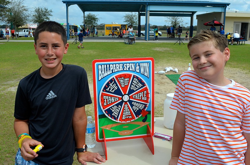 Friends, Alex Dine, 11, and Ronan Bray, 13, run a booth at the event.