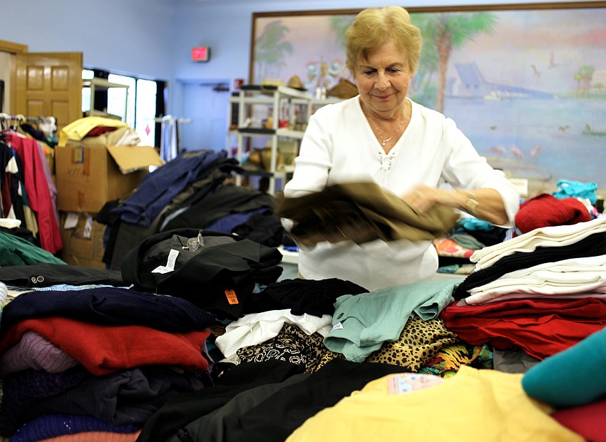 JoAnne Entwistle folds shirts in all colors and sizes for the sale.