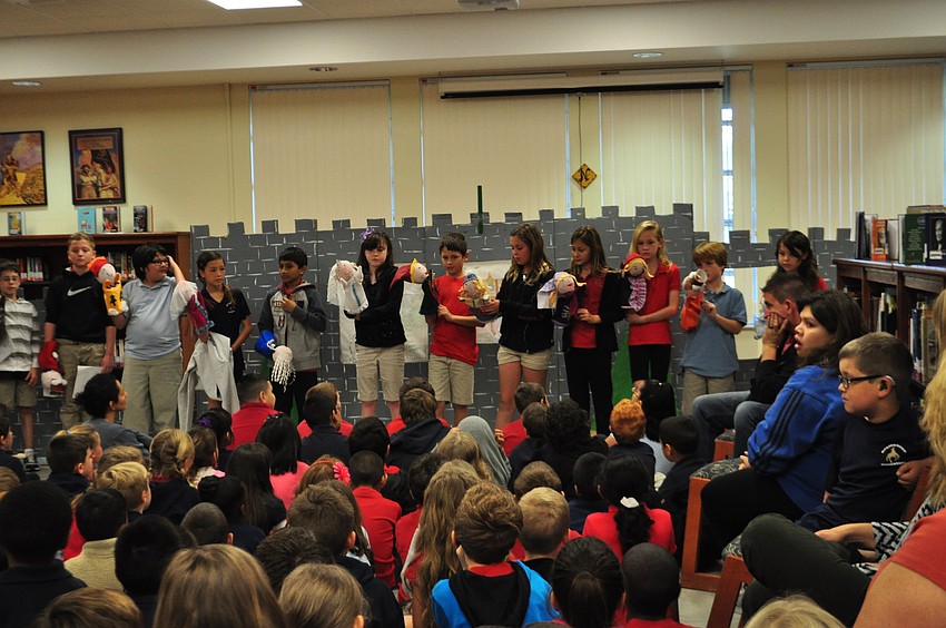 Students show off their puppets and answer questions after the performance.