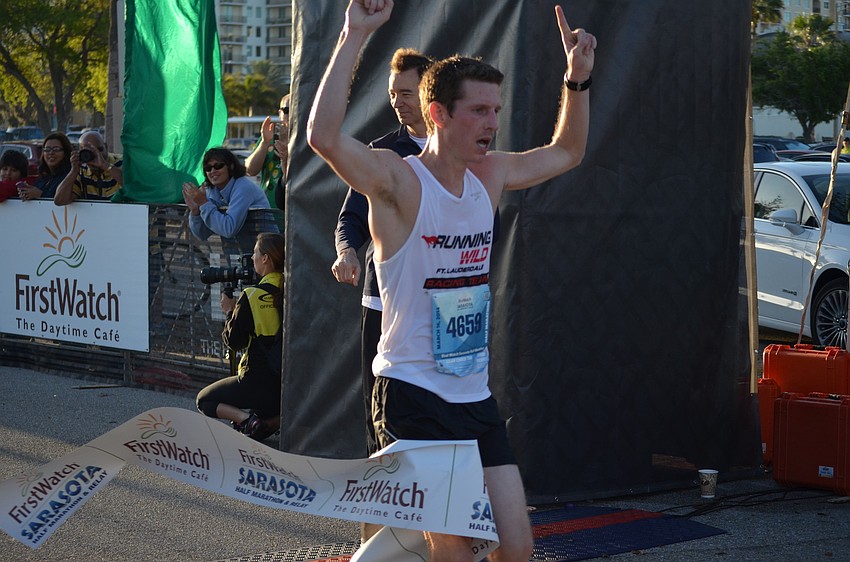 Evan DeHart crosses the finish line in first place.