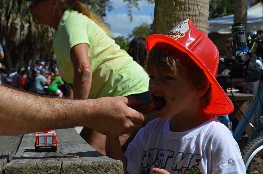 Jaxon Cail tries his first rib.