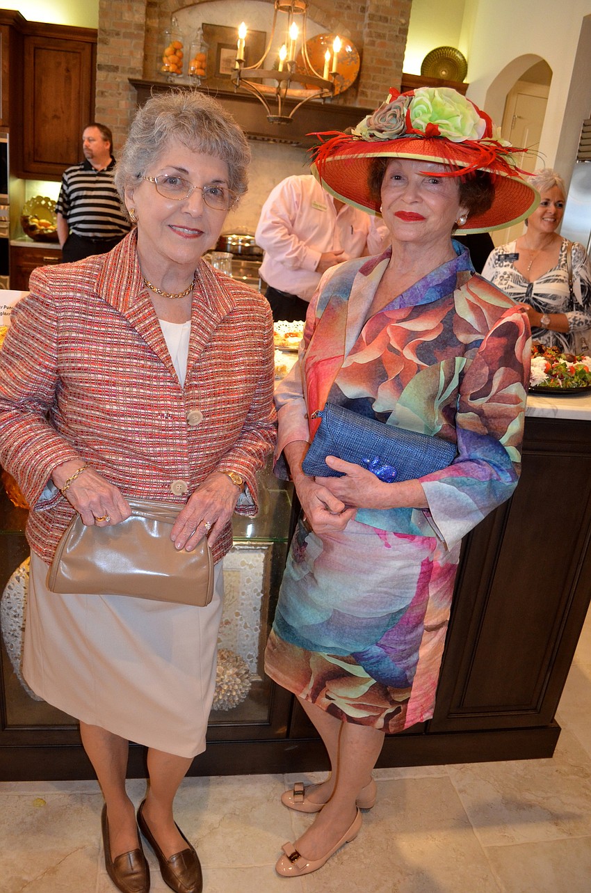 Dell Baird and Anne Boss show off their purses.