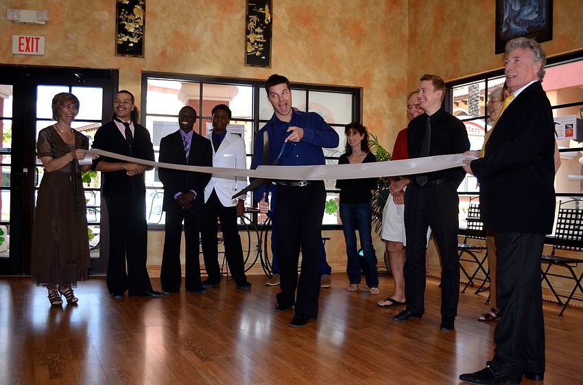 Jonathan Roberts cuts the ribbon on Cyntia and Patrick's new studio.