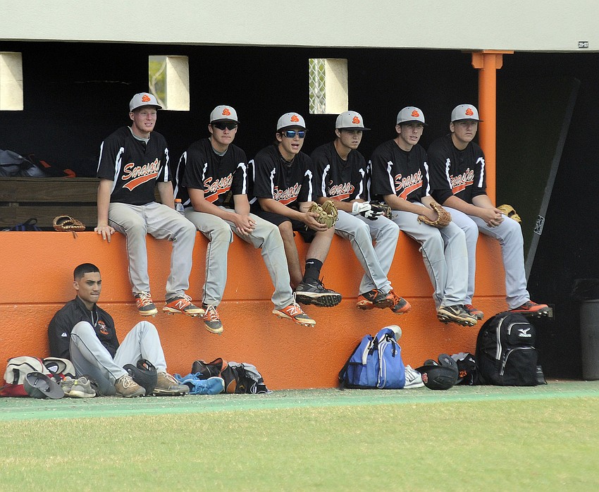 Members of the Sarasota High baseball team watch from the dugout as the Sailors look to get on the scoreboard in their first game of the Sarasota Baseball Classic.