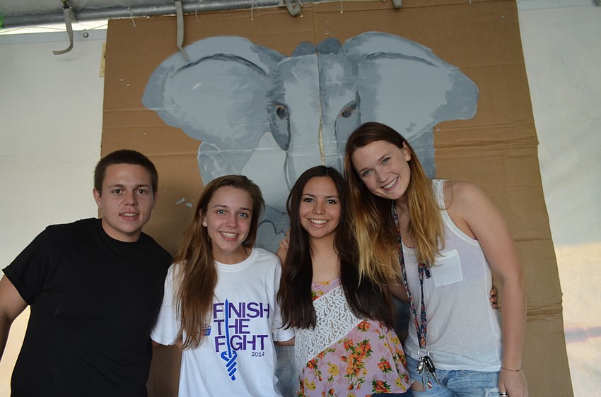Chris Caragher, Briana Easter, Rossalyn Delfino and Lauren Jeffrey work at Riverview High School's jungle-themed booth.