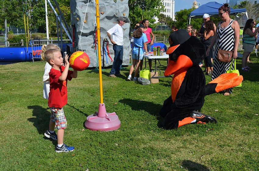 Sophia and Jeffrey Horr play tetherball with the Orioles Bird.