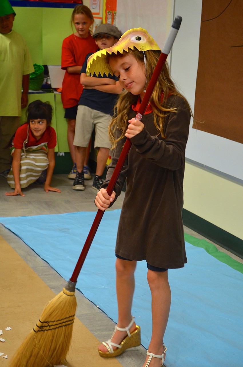 Dinerella, played by Kayden Withers, cleans up her evil sisters' mess.
