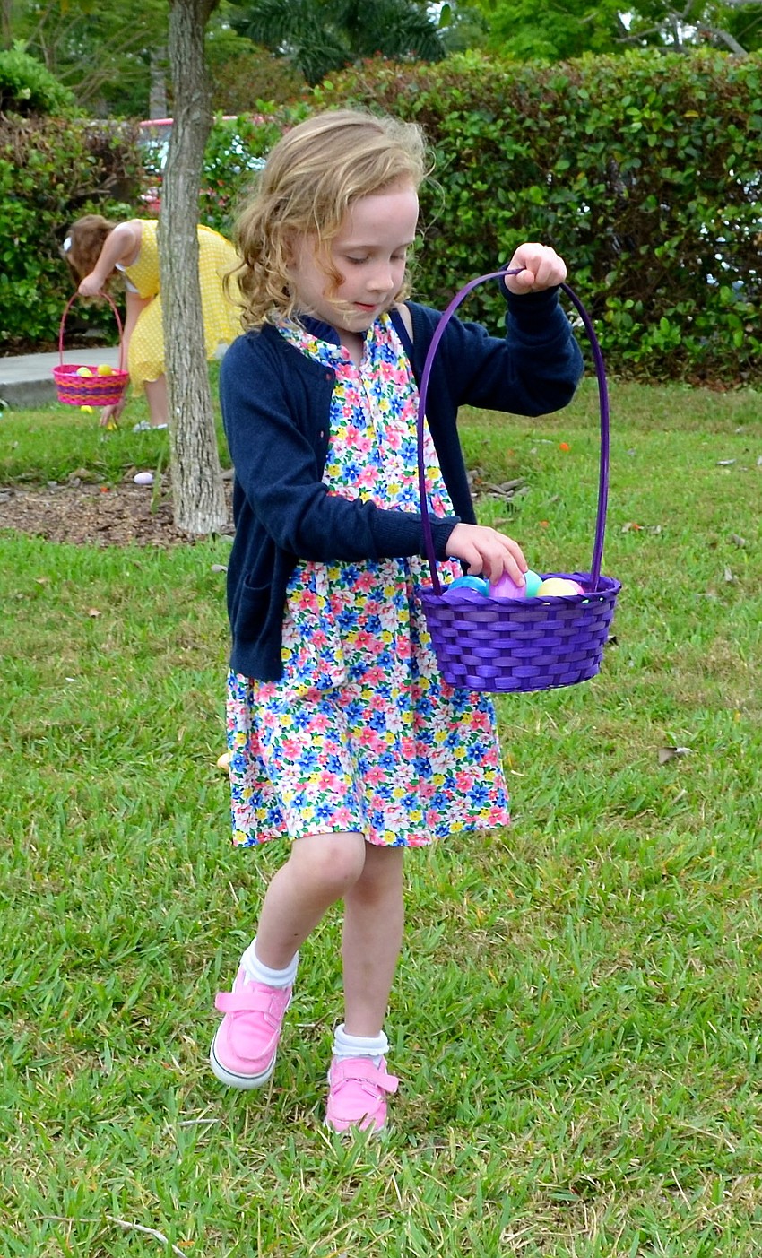 Marlee Bea adds another egg to her basket.