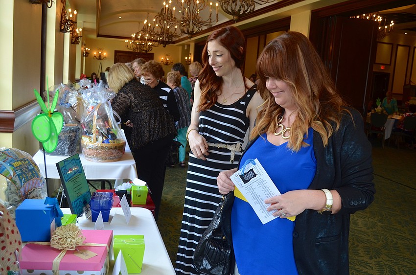 Jenni Ross and Darah Woomert look over raffle prizes.