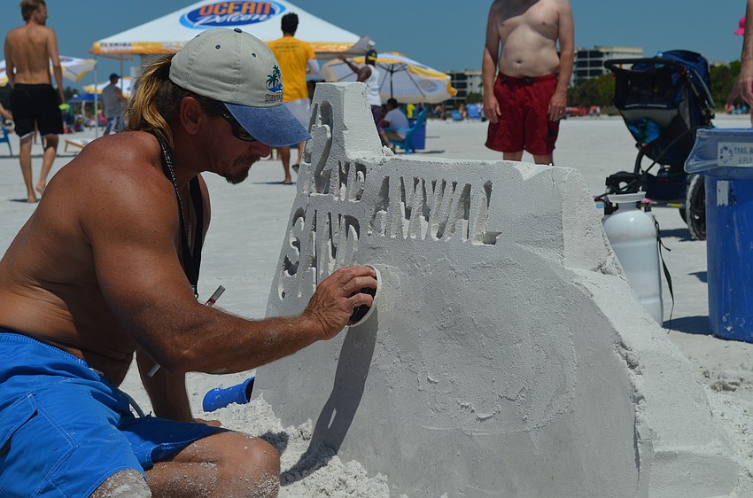 Andy Daily works on the sign.