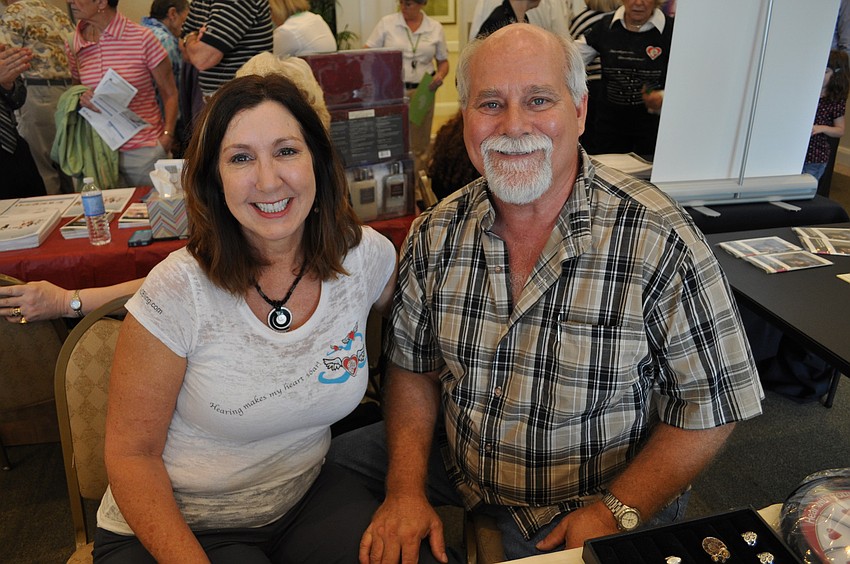 Dr. Noel Crosby, an audiologist, showed off cochlear-inspired jewelry with her husband, Michael.