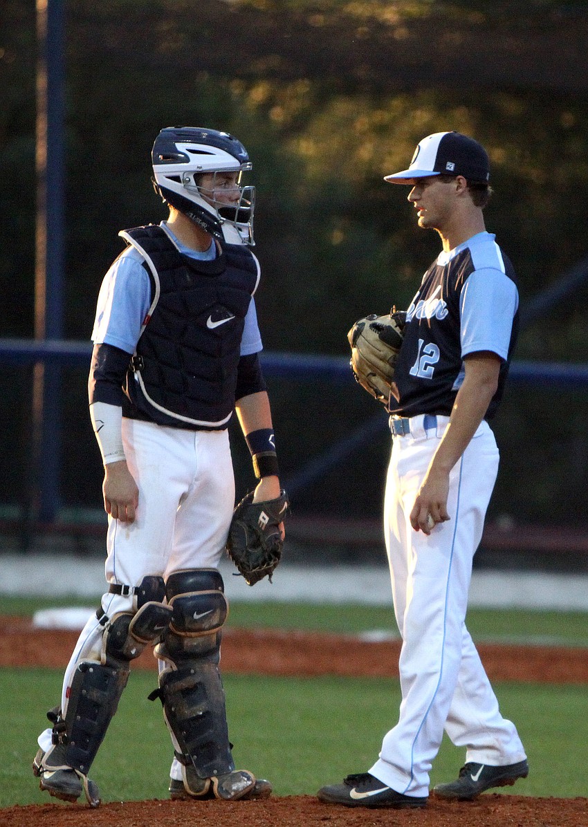 Out-of-Door Academyâ€™s Tyler Dietrich, No. 28, talks with teammate Austin Hoppe, No. 12, on the mound.