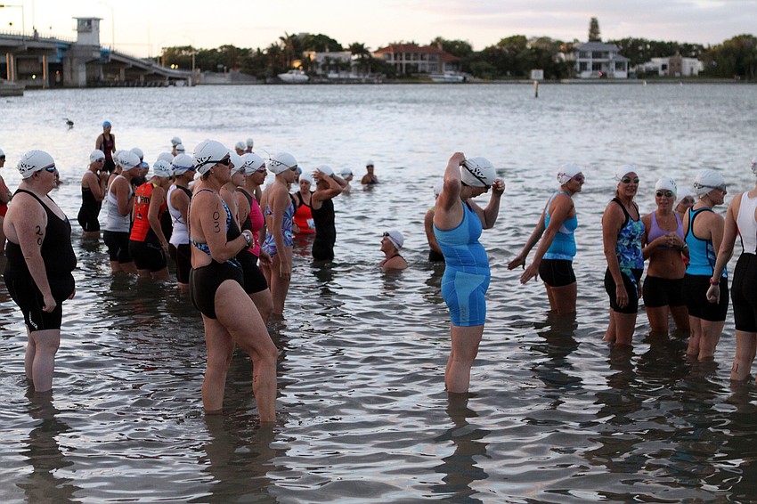 The women prepare to head into the water for the first portion of the sprint triathlon.