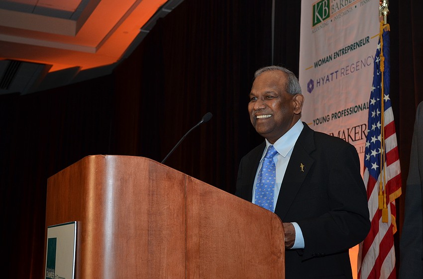 President Emeritus Dr. Kumar Mahadevan of Mote Marine Aquarium is presented with the Cultural Organization of the Year Award from sponsors IBERIABANK.