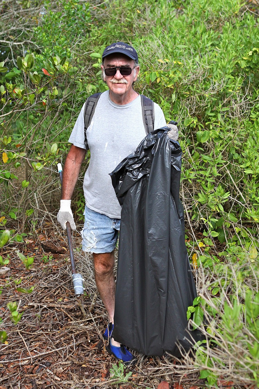 Mike McInerney shows off his garbage bag that was already half way full.