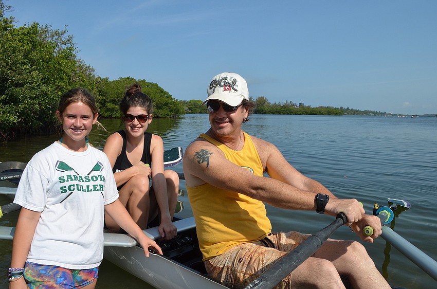 Lauren Steirball teaches her stepsister Cristina Conable and her stepdad Sam Conable how to row.