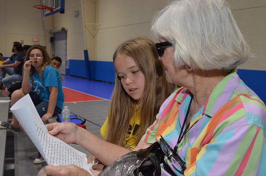 Grandmother Zoe Michael quizzes her granddaughter Isabella Hardin before the spelling bee.