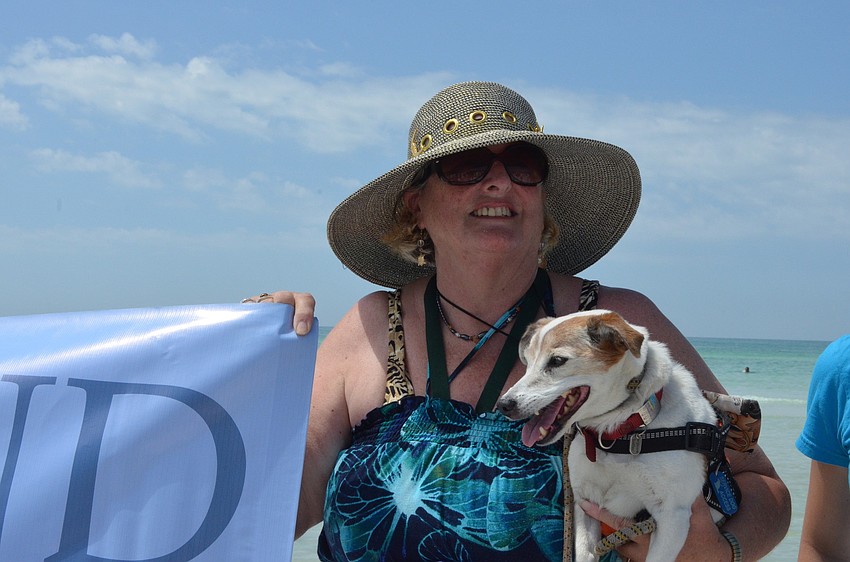 Gale Midwood came to show her support with her Jack Russell Terrier Saratoga. She says the beach and her service dog are both therapeutic for her.