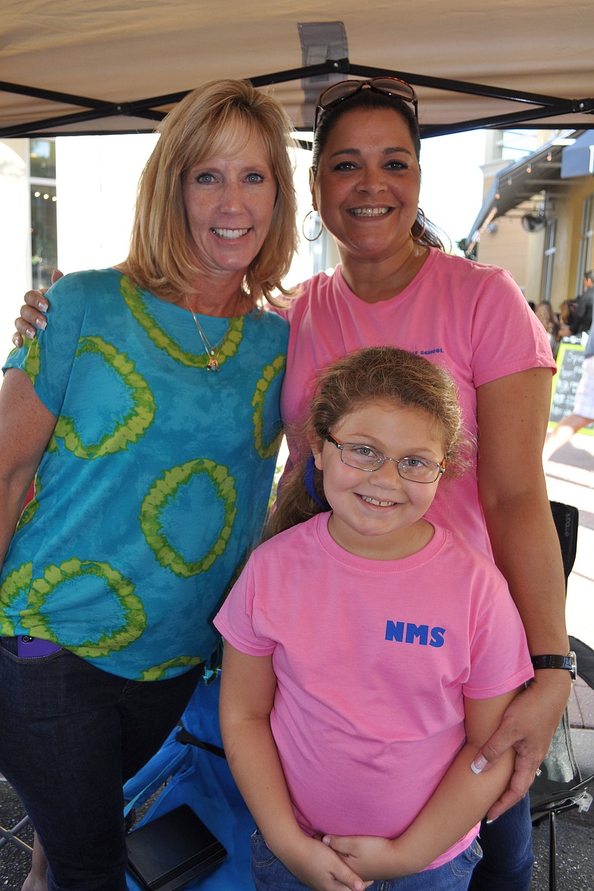 Kathy Dietz and Cornelia Levy, with her daughter, Megan, manned the Parent-Teacher Organization booth.