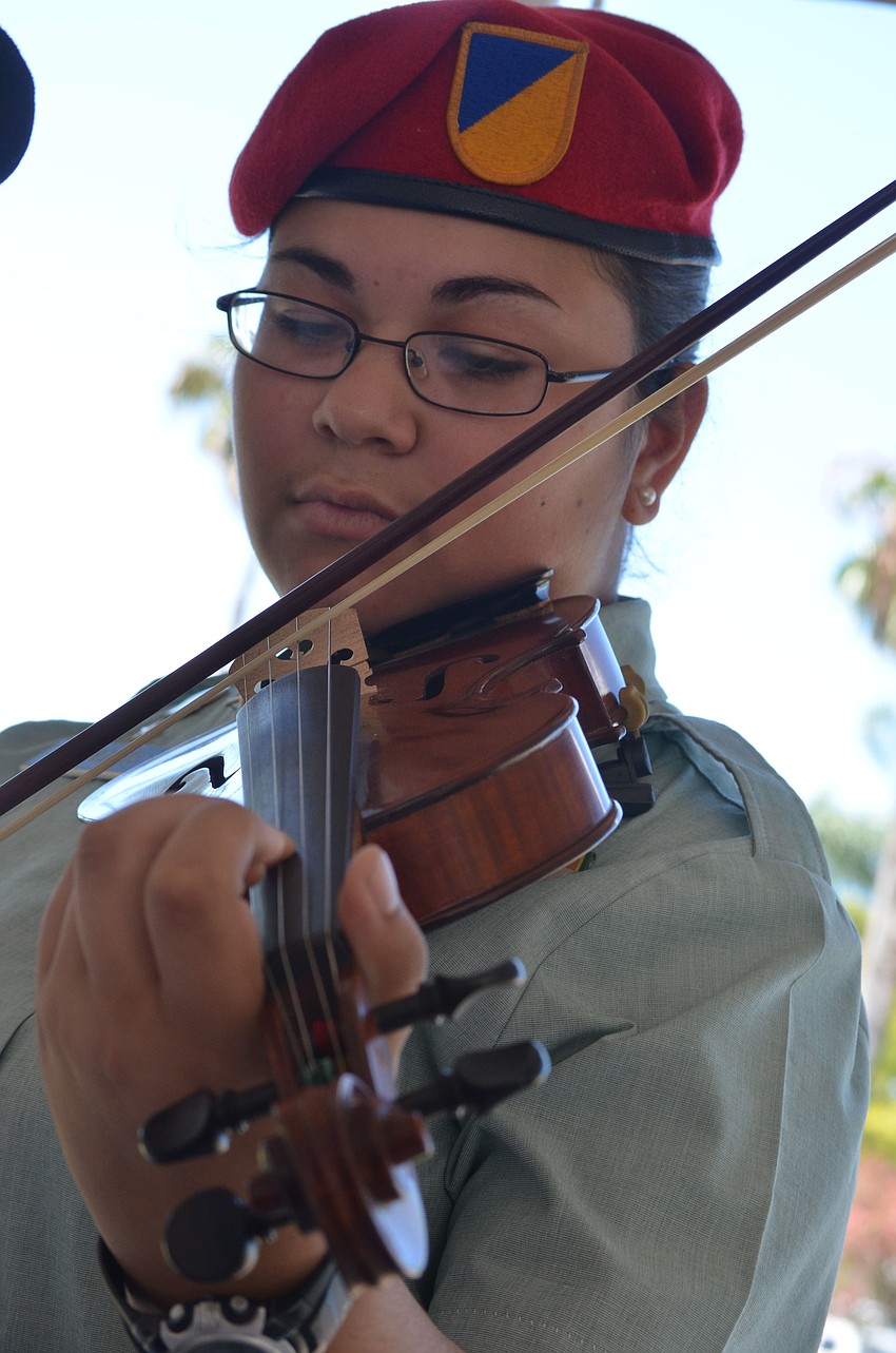 Sarasota Military Academy sophomore Gracie Cespedes plays the National Anthem on the violin at the ceremony after the parade.