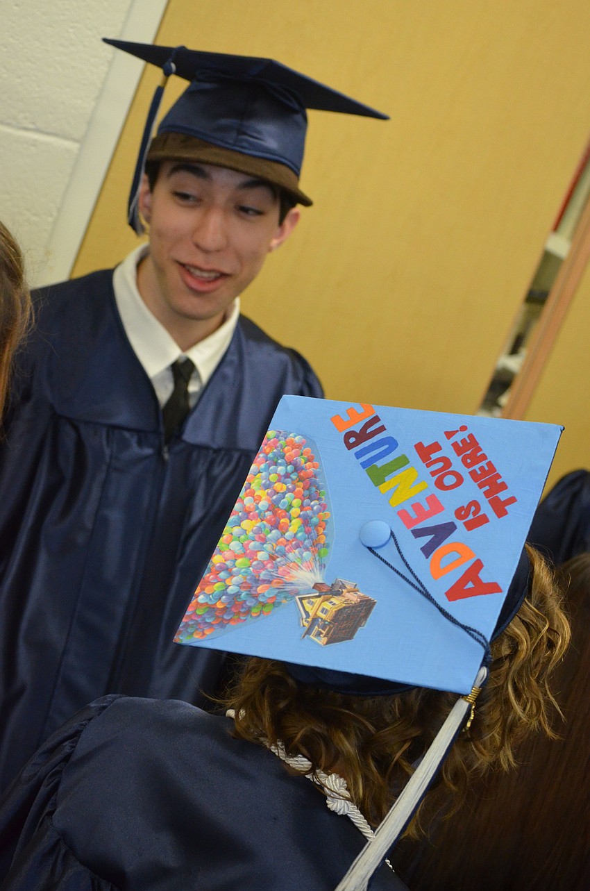 Students decorated their graduation caps with university names and creative quotes. Melanie Masonâ€™s cap read â€œAdventure is out there,â€ from Pixarâ€™s animated film UP.