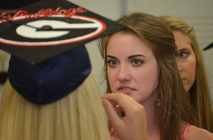 Kelly Doyle talks with friends before putting on her cap and gown. She will attend the University of Georgia in the fall, where she plans to go study pre-medicine.